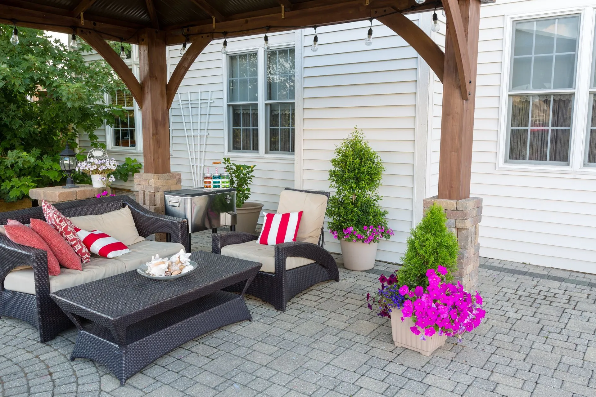 Paver patio with outdoor seating and a pergola at the rear of a home